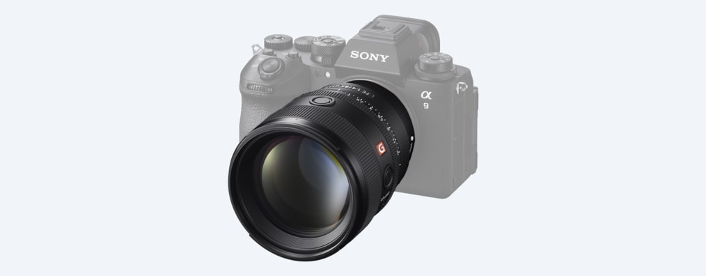 A product image showing the lens mounted on the desaturated α9 III